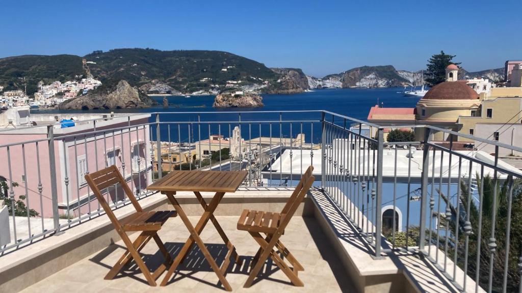 a table and chairs on a balcony with a view of the water at La Parata in Ponza
