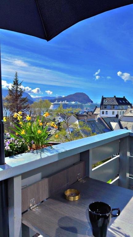 a balcony with a table and a view of a city at Leilighet med sydvendt balkong in Ålesund