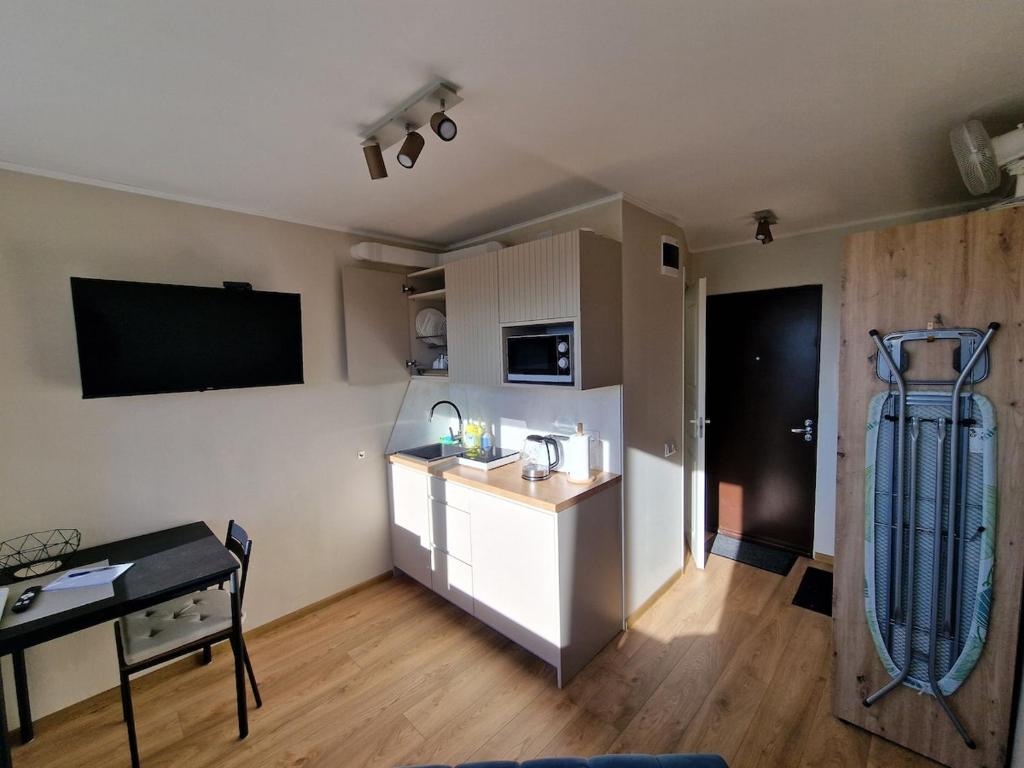 a kitchen with a counter and a table in a room at Mini apartment for one person in Tallinn