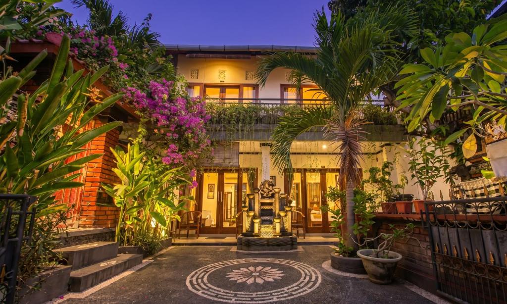 an exterior view of a house with plants at Pondok Taksu Bali in Kuta