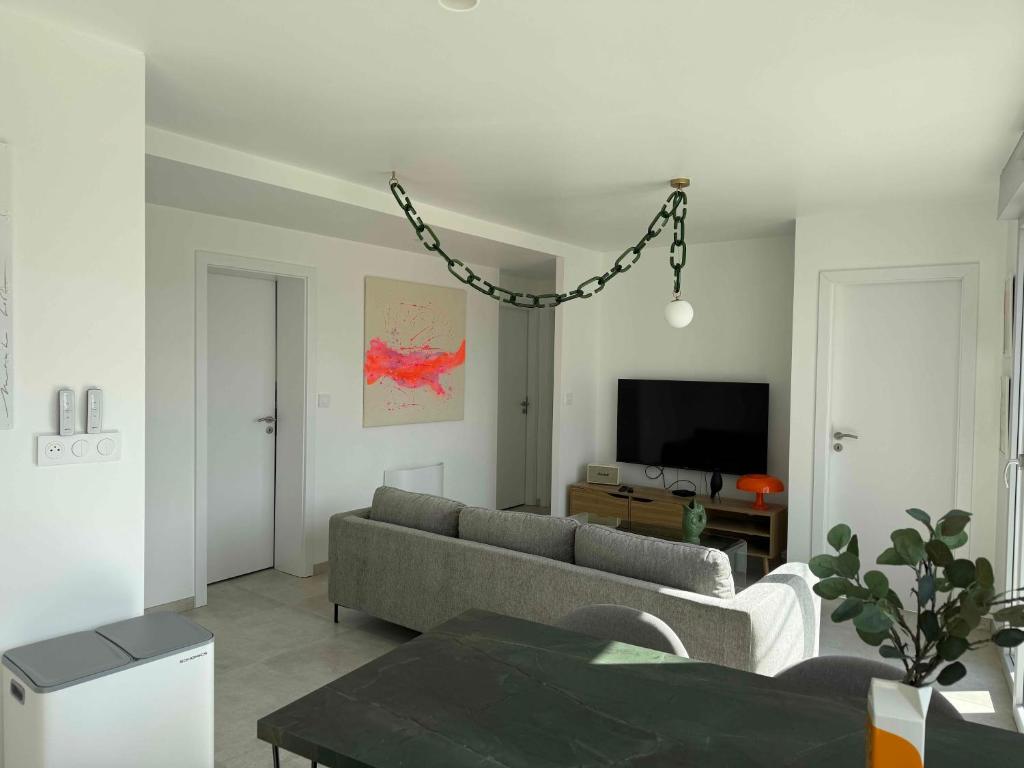 a living room with a couch and a tv at La Bergerie 3 in Neufchâteau