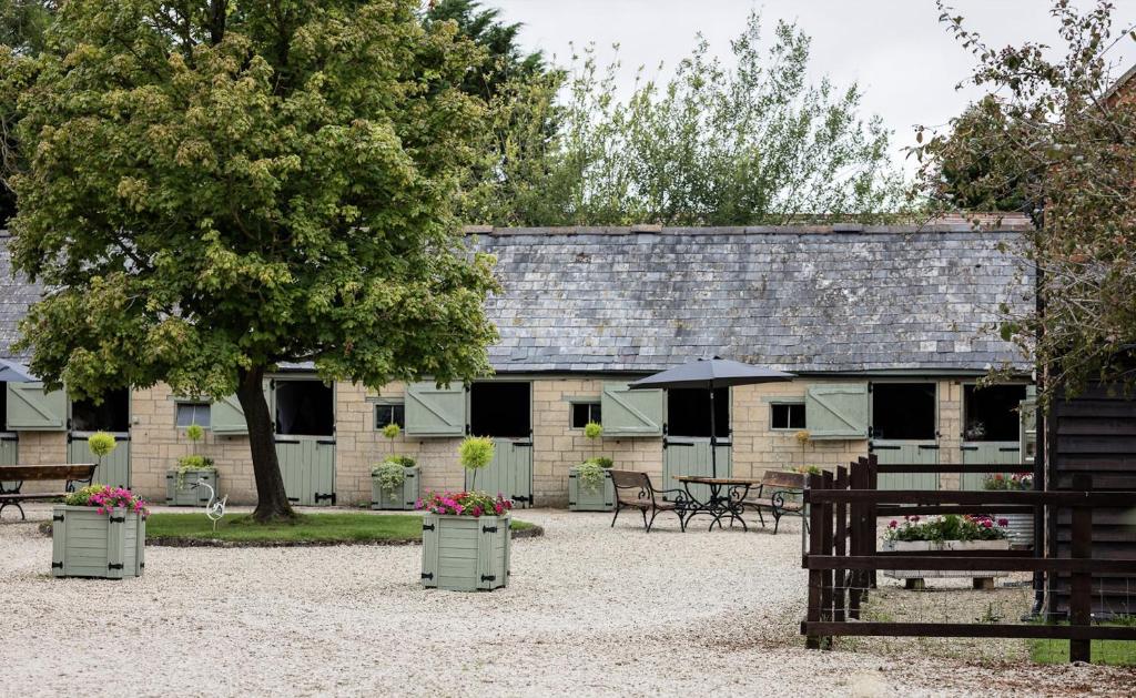 a building with benches and tables and an umbrella at Hill Farm in Oxford