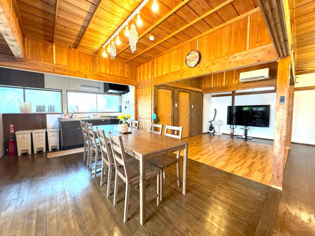 a kitchen and dining room with a table and chairs at Ango KIKAIJIMA in Onozu