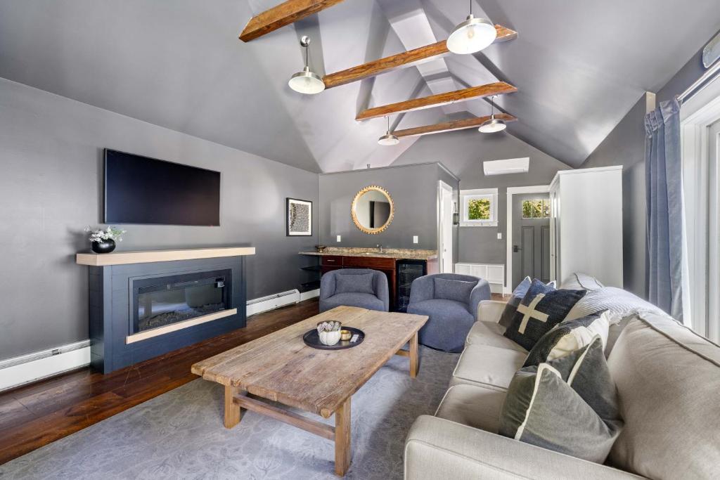 a living room with a couch and a fireplace at KPT Salt Pine House Apartment in Kennebunkport
