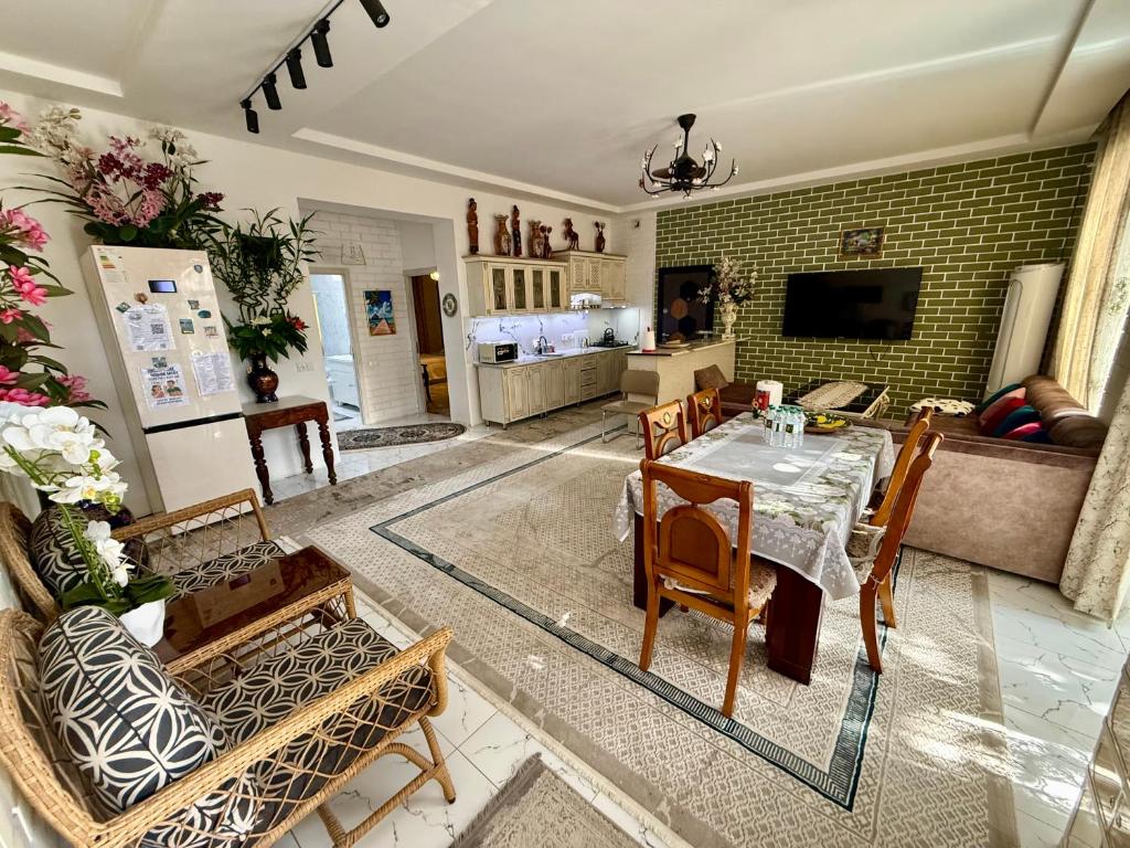 a living room with a table and chairs at Duplex80A in Tashkent