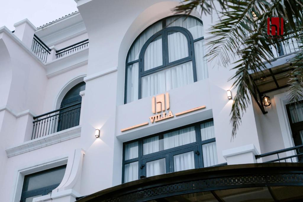a white building with a hotel sign on it at HL Villa in Dong Hoi