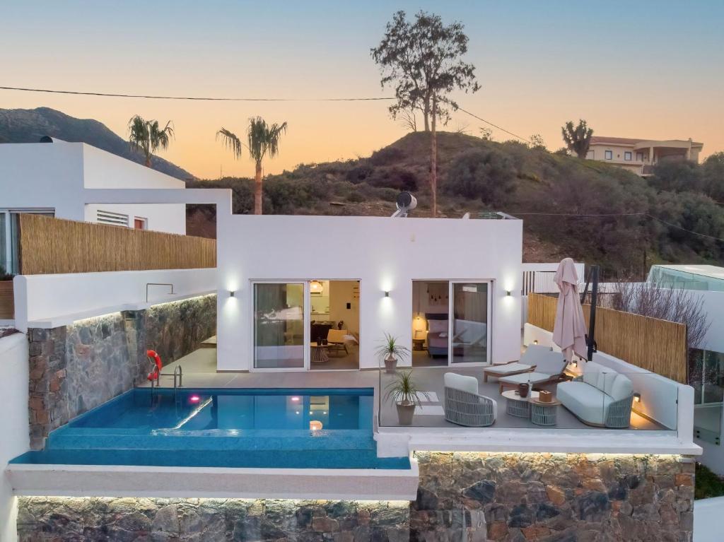 a villa with a swimming pool and a house at villa yasmin luxury in Bali
