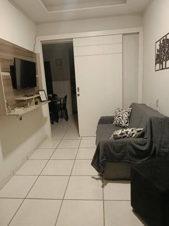 a living room with a couch and a television at Casa de clecia in Natal