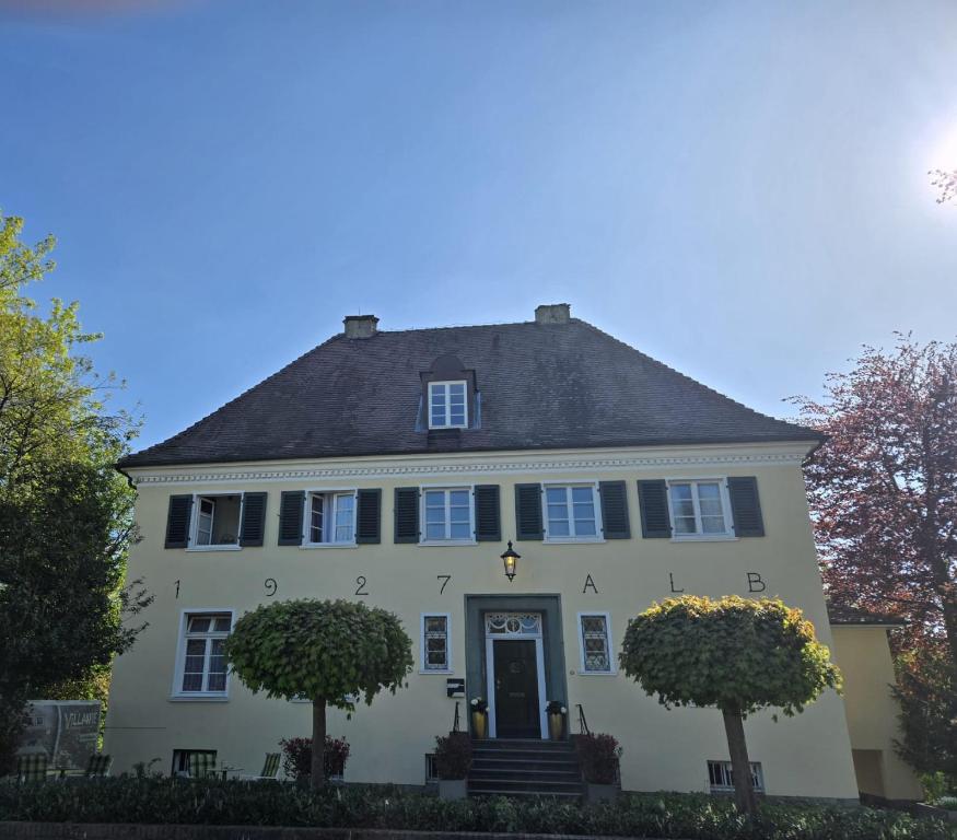 a white house with a black roof at VillaWie in Rheda-Wiedenbrück