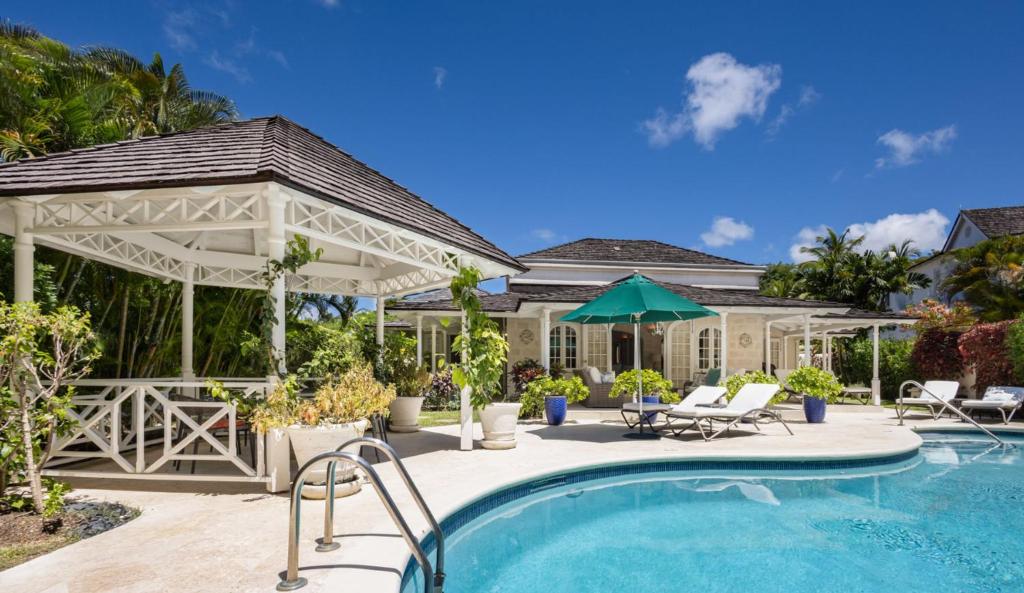 a house with a pool and a gazebo at Royal Westmoreland Lonetrees - by ZenBreak in Saint James
