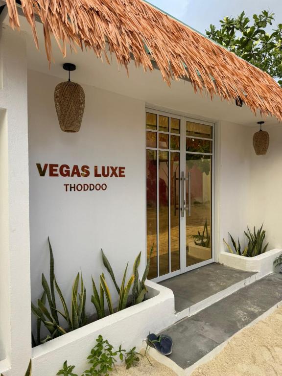 a white building with a versas live logo on it at Vegas Luxe Thoddoo in Thoddoo