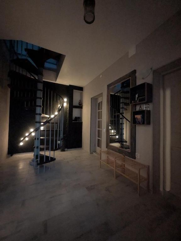 a living room with a staircase and a mirror at Gala Kambaris in Myza Bene