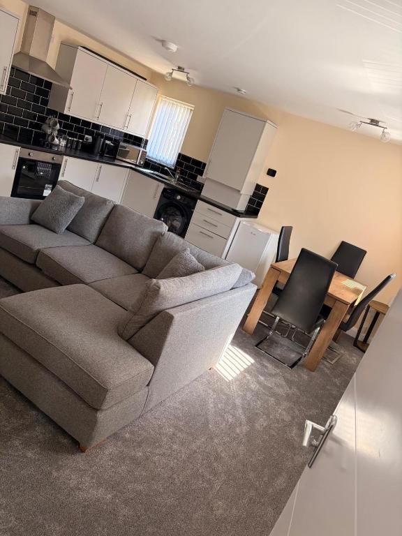 a living room with a couch and a table at Easy living stays Burton on Trent in Burton upon Trent