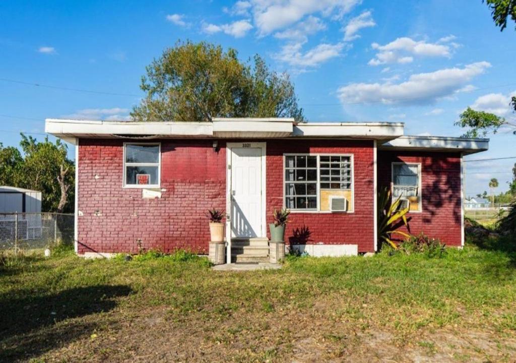a small red brick house with a white door at GpL 3321 Downtown Fort Myers Retreat in Fort Myers
