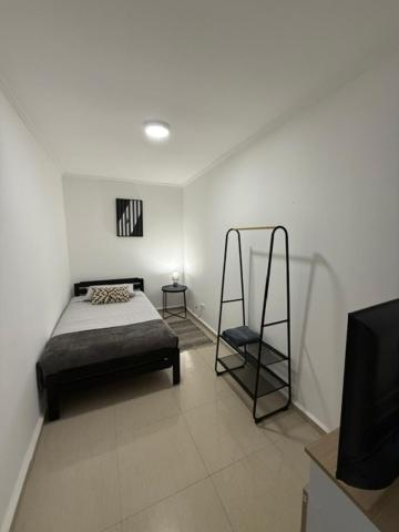 a bedroom with a bed and a tv in it at Casa Hostal , Mejillones in Mejillones