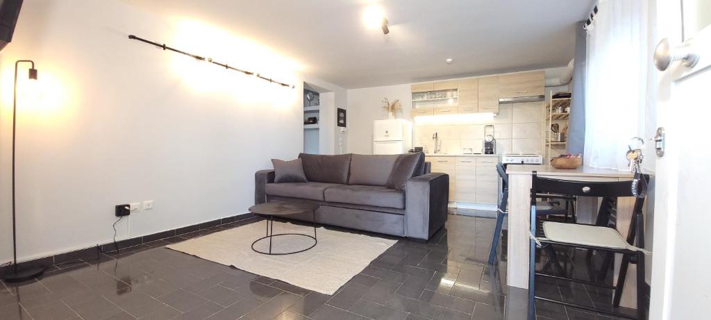 a living room with a couch and a kitchen at West Garden At Aigio By Greece Apartments in Aigio