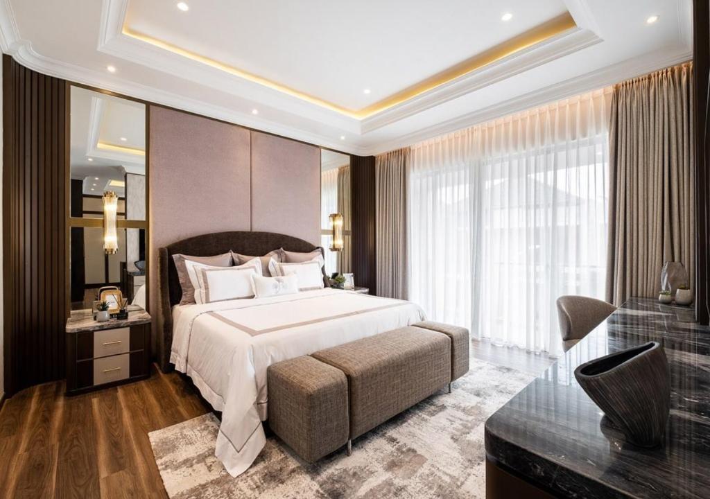 a bedroom with a large bed and a large window at Hotel Belwood De Near Delhi Airport IGI in New Delhi