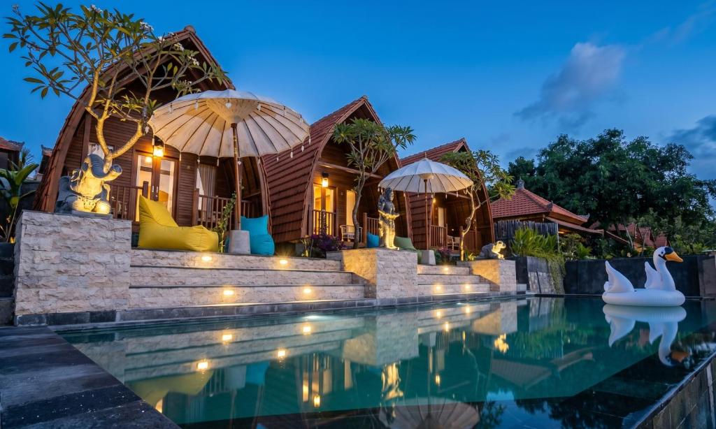 a villa with a swimming pool at night at Permata Hill Nusa Penida in Nusa Penida