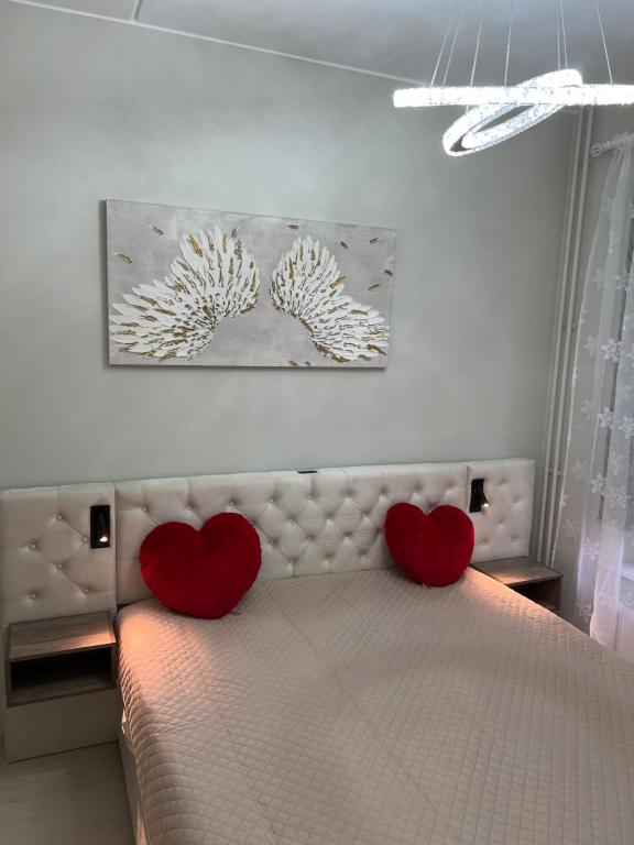 two hearts on a bed in a bedroom at Modern Apartment i Solna in Solna