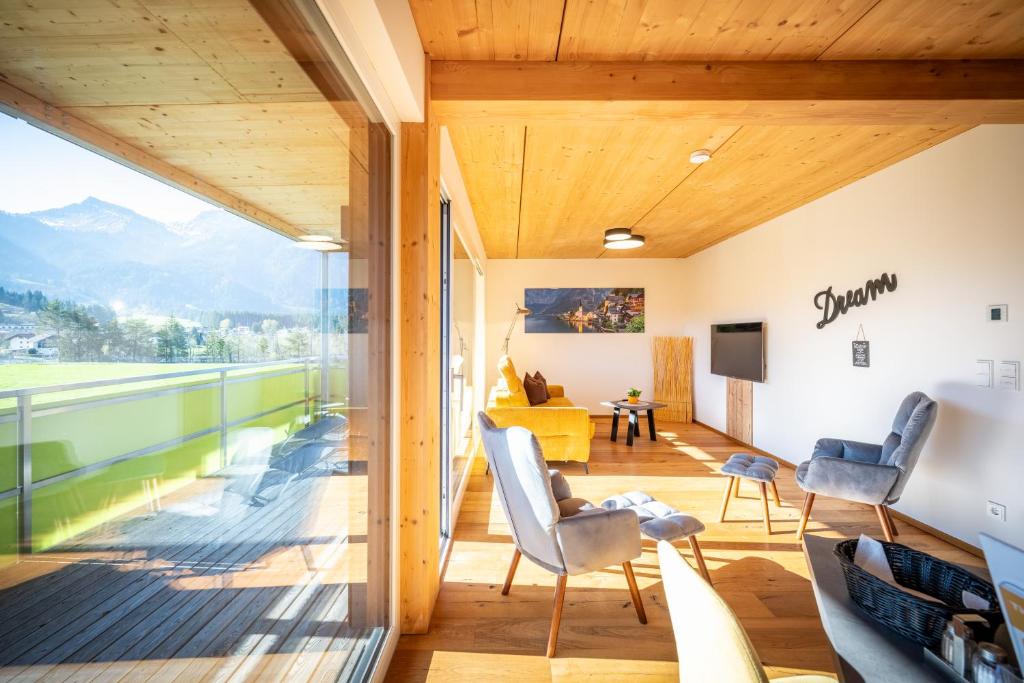 a room with a balcony with a view of the mountains at Alpenapart Singer - contactless check-in in Reutte