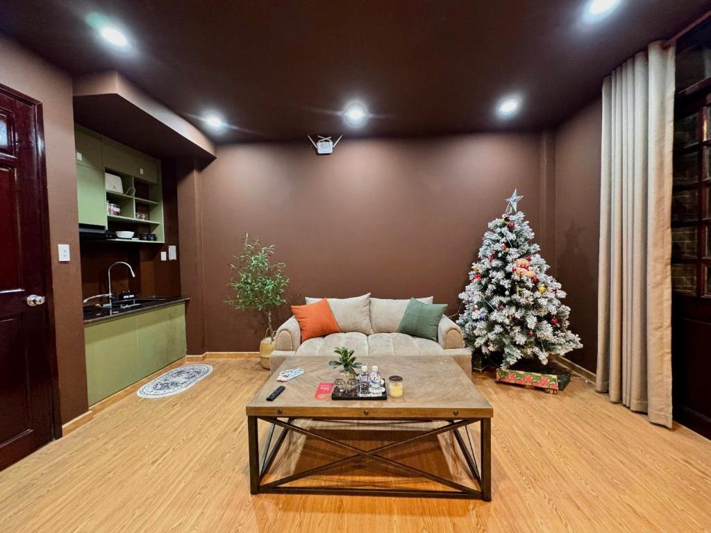 a living room with a christmas tree and a couch at Uh Homestay Thảo Điền in Ho Chi Minh City