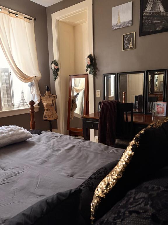 a bedroom with a bed and a desk and a mirror at Graystone Manor in Albion