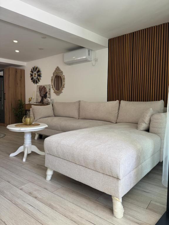 a living room with a couch and a table at Mille in Igalo