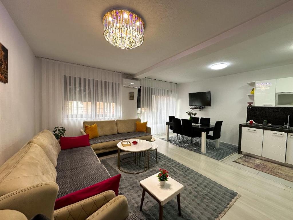 a living room with a couch and a table at Prishtina Guests in Prishtinë