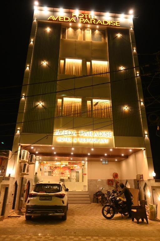 a car parked in front of a building at night at Hotel Aveda Paradise in Varanasi