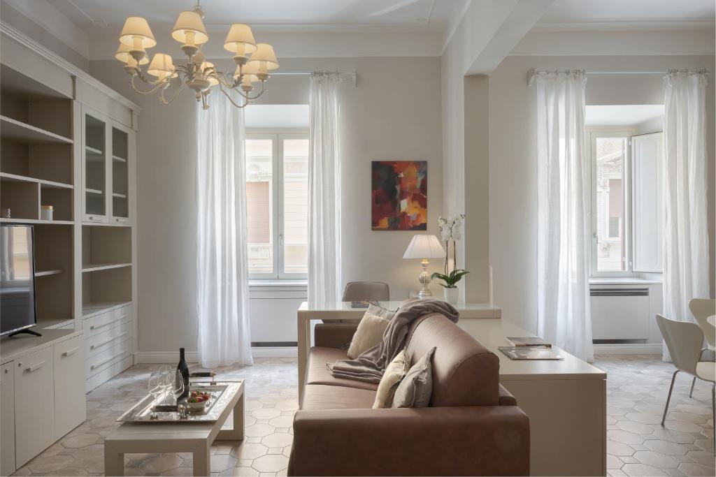 a living room with a couch and a table at Altarocca Embassy Rome in Rome