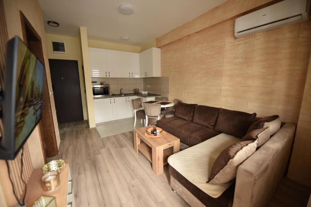 a living room with a couch and a table at Apartman Valentina Aqua Park in Jagodina