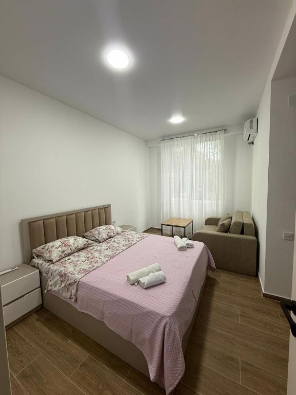 a bedroom with a bed with two towels on it at Grigoleti Royal in Grigoleti