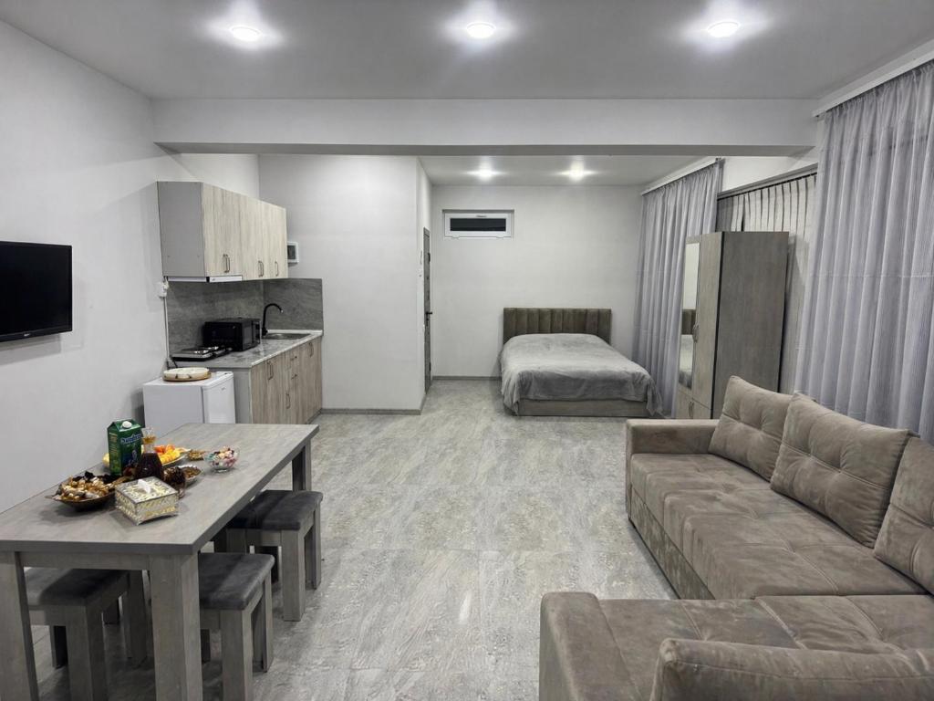 a living room with a couch and a table and a bed at Manes in Yeghegnadzor