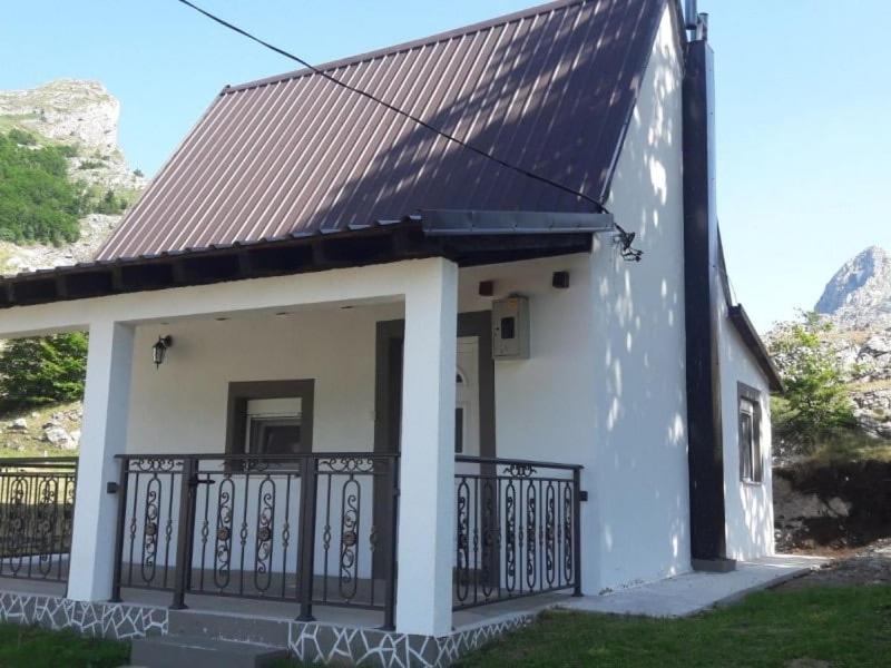 a small white house with a metal roof at Vikendica Ivanović in Prisoja