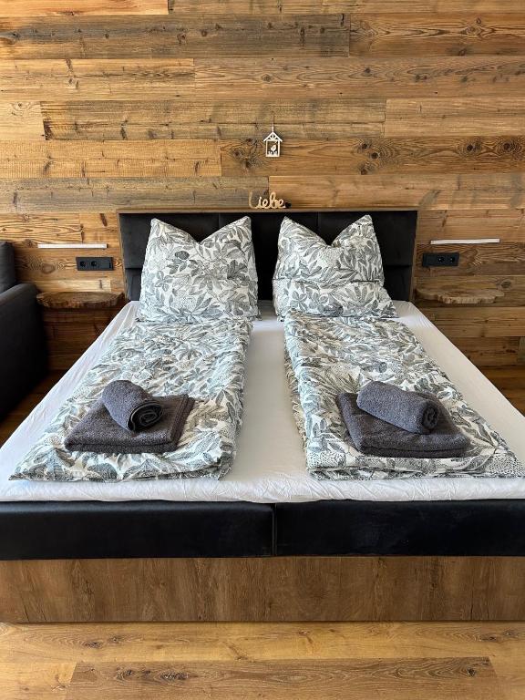 a bed in a room with two pillows on it at Staufen Stern in Oberstaufen