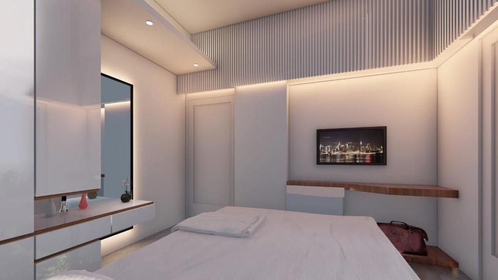a bedroom with a bed and a tv on the wall at Hotel Adi International in Rājshāhi