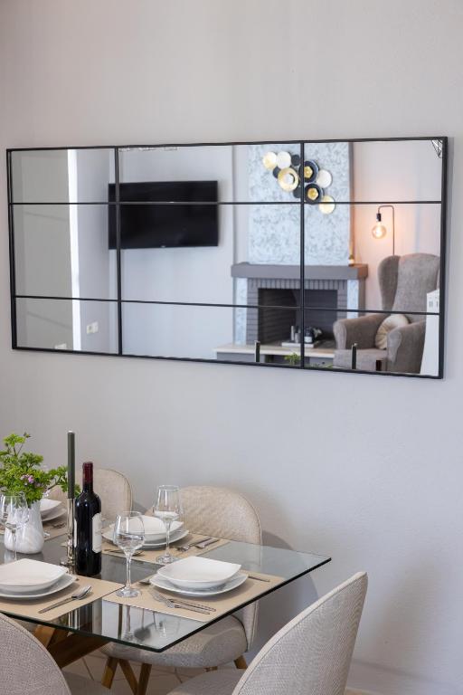 a dining room with a glass table and chairs at Electras house in Kassandra