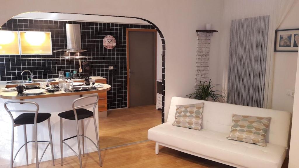 a living room with a white couch and a table at venice la pergola n 3 in Spinea