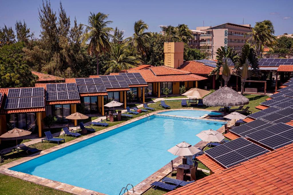 an overhead view of a swimming pool with solar panels at Hotel Velejar in Cumbuco