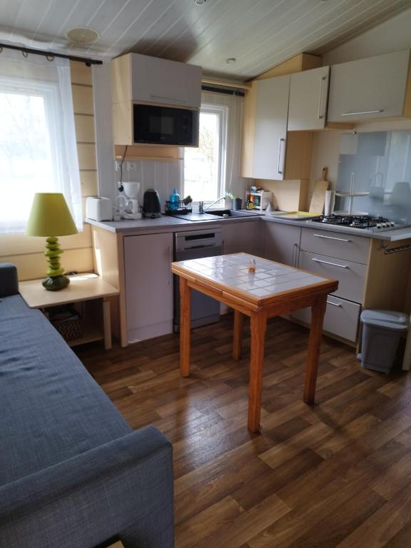 a kitchen with a table in the middle of it at Chez François in Crouay