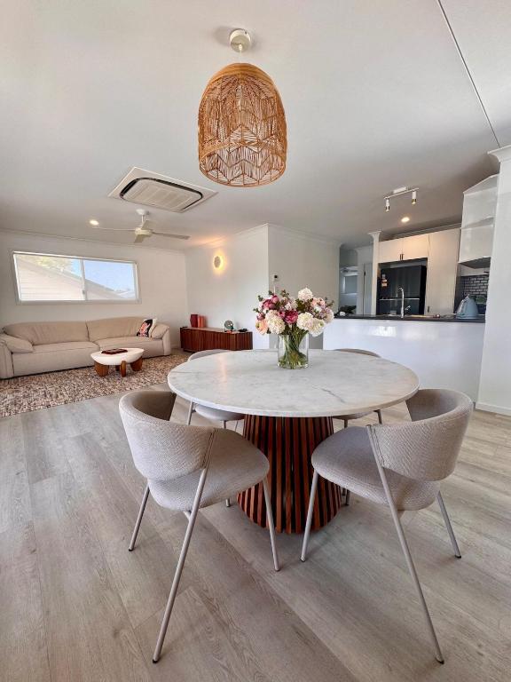 a kitchen and living room with a table and chairs at Spacious Private 2BR Guest Suite in Gold Coast
