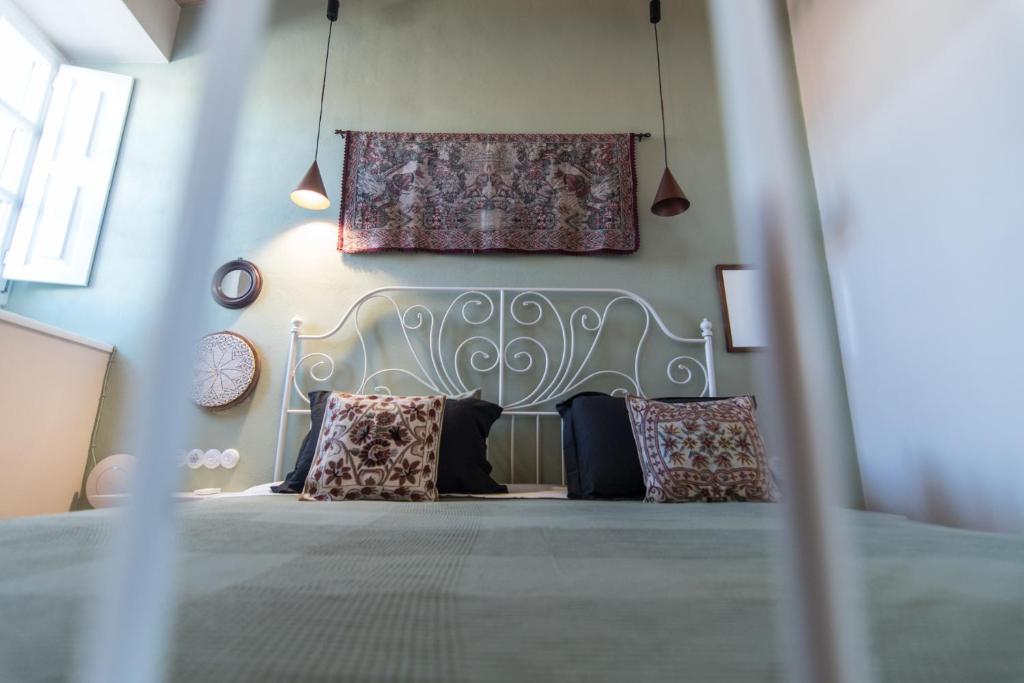 a bedroom with a bed with pillows on it at Almond Suite in Hydra