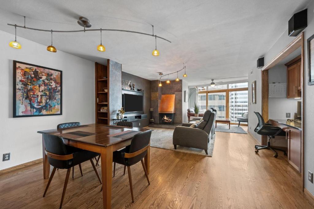 a dining room and living room with a table and chairs at 1777 Larimer 2211 in Denver