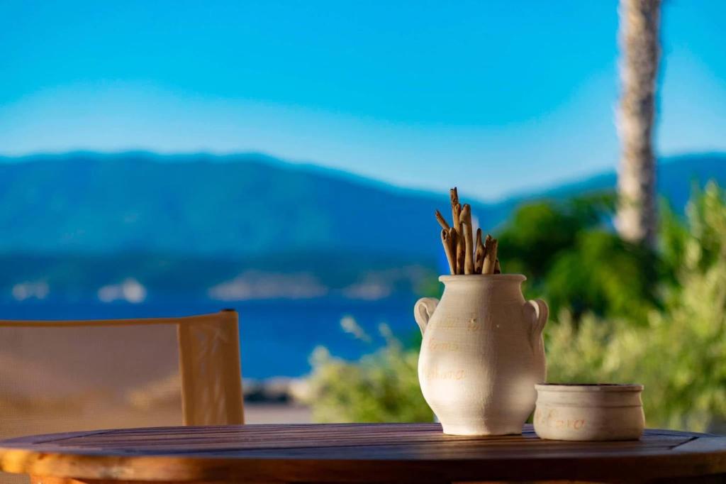 a white vase sitting on top of a table at Vasiliki Palli Rooms in Methana