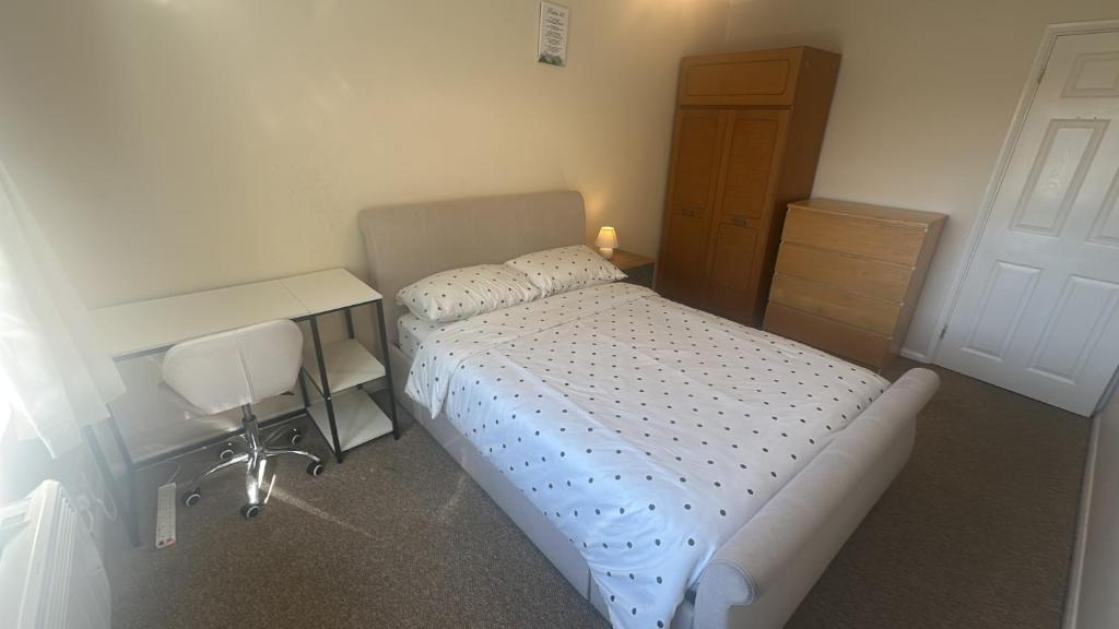 a small bedroom with a bed and a desk at Edney Court in Reading