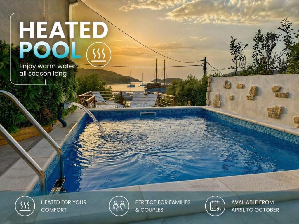 a heated pool with a water feature in a house at Beach Villa Ema with Heated Pool in Rab