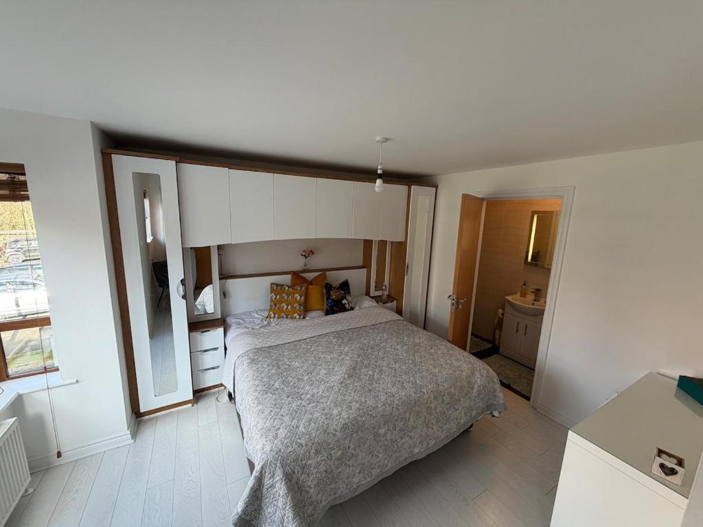a bedroom with a large bed and a window at Relax In Belfast in Belfast