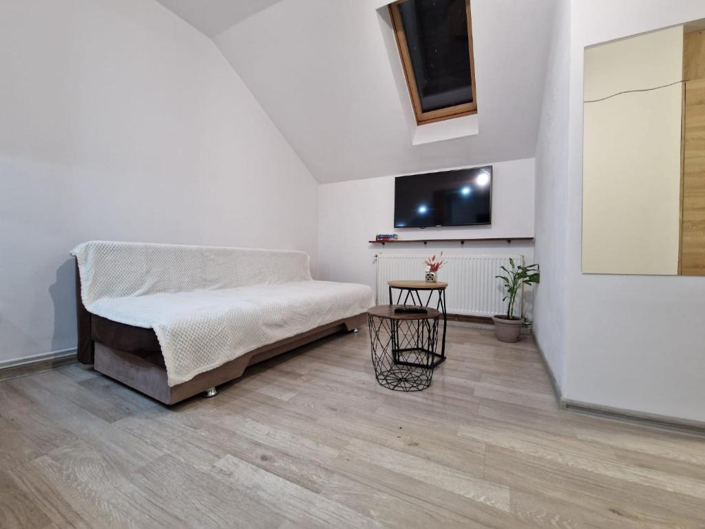 a white room with a bed and a tv at Dixi Studio in Timişoara