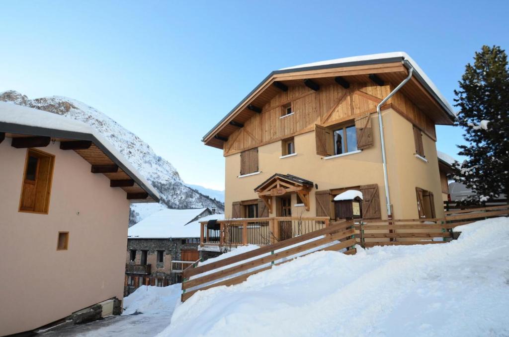 a house in the snow next to a building at Chalet De Manou - Chalet individuel rénové pour 12 personnes avec sauna dans les 3 Vallées MAE-3694 in Saint-Martin-de-Belleville