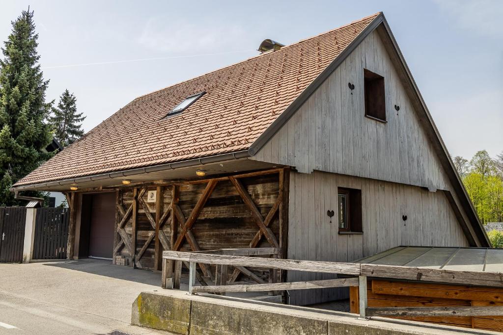 a large wooden barn with a brown roof at Pr' Sokrat in Radovljica